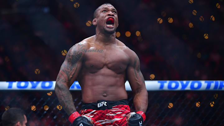 Jan 18, 2025; Inglewood, California, USA; Jailton Almeida (red gloves) celebrates after defeating Serghei Spivac (blue gloves) during UFC 311 at Intuit Dome. Mandatory Credit: Gary A. Vasquez-Imagn Images