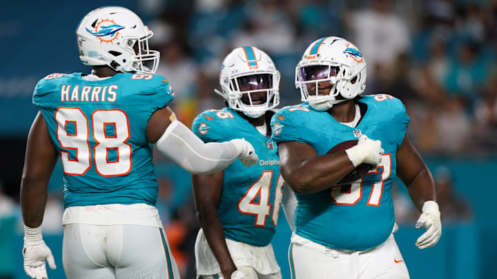Miami Dolphins defensive tackle Isaiah Mack (97) celebrates with defensive tackle Jonathan Harris (98) after recovering a fumble against the Atlanta Falcons in the second quarter during preseason at Hard Rock Stadium.