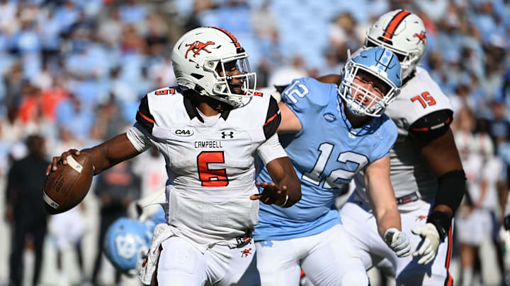 Nov 4, 2023; Chapel Hill, North Carolina, USA; Campbell Fighting Camels quarterback Hajj-Malik Williams (6) looks to pass as North Carolina Tar Heels defensive lineman Beau Atkinson (12) pressures in the third quarter at Kenan Memorial Stadium. Mandatory Credit: Bob Donnan-Imagn Images Nov 4, 2023; Chapel Hill, North Carolina, USA; Campbell Fighting Camels quarterback Hajj-Malik Williams (6) looks to pass as North Carolina Tar Heels defensive lineman Beau Atkinson (12) pressures in the third quarter at Kenan Memorial Stadium. Mandatory Credit: Bob Donnan-Imagn Images