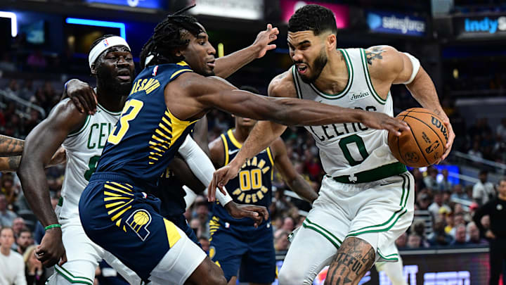 Oct 30, 2024; Indianapolis, Indiana, USA; Indiana Pacers forward Aaron Nesmith (23) gets a hand on a ball controlled by Boston Celtics forward Jayson Tatum (0) during the second half at Gainbridge Fieldhouse. Mandatory Credit: Marc Lebryk-Imagn Images