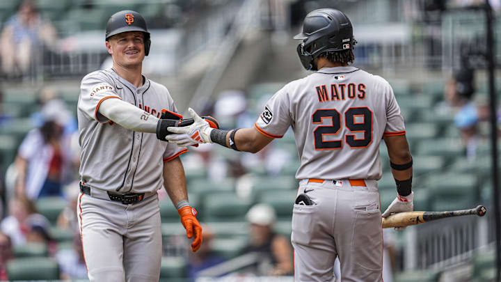 Jul 23, 2025; Cumberland, Georgia, USA; San Francisco Giants third baseman Matt Chapman (26) reacts with right fielder Luis Matos (29) after scoring a run against the Atlanta Braves during the seventh inning at Truist Park.