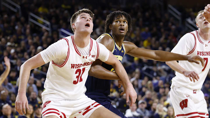 Jan 10, 2026; Ann Arbor, Michigan, USA;  Wisconsin Badgers forward Nolan Winter (31) and Michigan Wolverines forward Morez Johnson Jr. (21) look for a rebound in the first half at Crisler Center. Mandatory Credit: Rick Osentoski-Imagn Images