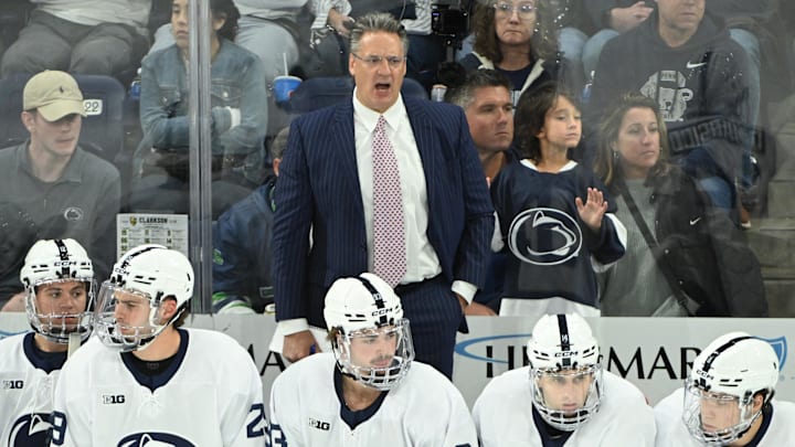 Penn State Nittany Lions men's hockey head coach Guy Gadowsky watches the action against the Clarkson Golden Knights in the first period of a game at Pegula Ice Arena. Penn State Nittany Lions men's hockey head coach Guy Gadowsky watches the action against the Clarkson Golden Knights in the first period of a game at Pegula Ice Arena.