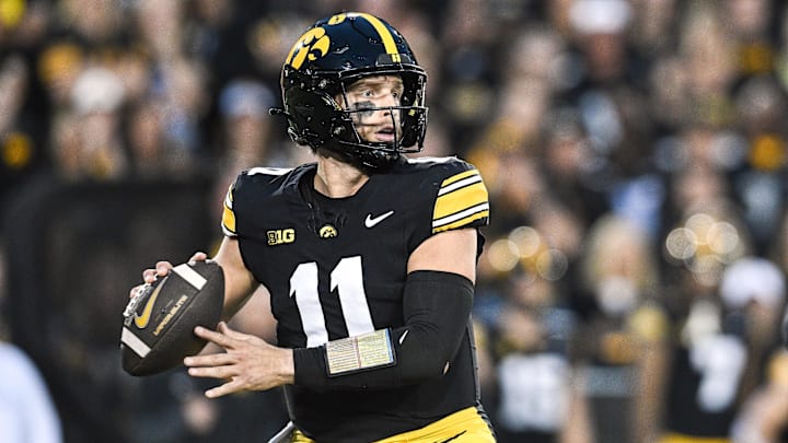 Oct 18, 2025; Iowa City, Iowa, USA; Iowa Hawkeyes quarterback Mark Gronowski (11) prepares to throw a pass against the Penn State Nittany Lions during the first quarter at Kinnick Stadium. Mandatory Credit: Jeffrey Becker-Imagn Images