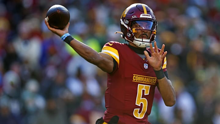 Dec 22, 2024; Landover, Maryland, USA; Washington Commanders quarterback Jayden Daniels (5) throws a pass during the first quarter against the Philadelphia Eagles at Northwest Stadium. Mandatory Credit: Peter Casey-Imagn Images
