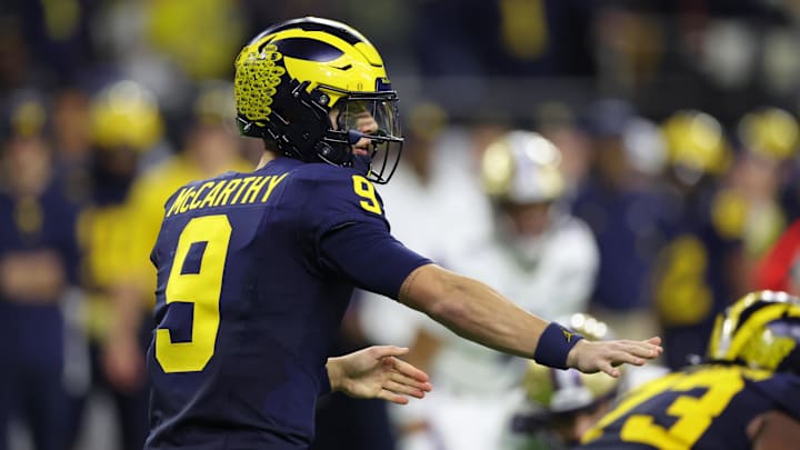 Jan 8, 2024; Houston, TX, USA; Michigan Wolverines quarterback J.J. McCarthy (9) gestures to teammates before a snap against the Washington Huskies during the third quarter in the 2024 College Football Playoff national championship game at NRG Stadium. Mandatory Credit: Thomas Shea-Imagn Images
