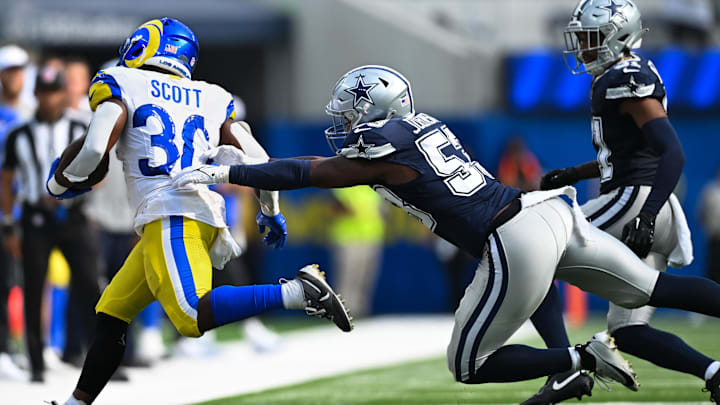 Los Angeles Rams running back Boston Scott runs the ball to the sidelines against Dallas Cowboys linebacker Jason Johnson 