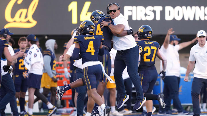 Cal outside linebackers coach Vic So'oto celebrates with players in 2023