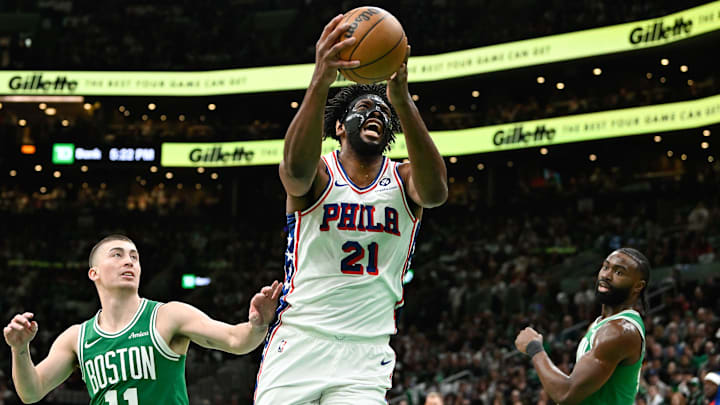 Dec 25, 2024; Boston, Massachusetts, USA; Philadelphia 76ers center Joel Embiid (21) shoots through the defense of Boston Celtics guard Payton Pritchard (11) during the first half at TD Garden. Mandatory Credit: Eric Canha-Imagn Images