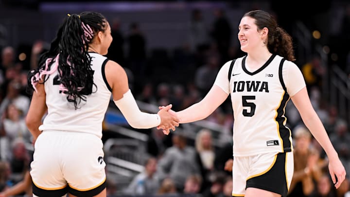 Mar 7, 2026; Indianapolis, IN, USA; Iowa Hawkeyes forward Hannah Stuelke (45) and Iowa Hawkeyes center Ava Heiden (5) high-five against the Michigan Wolverines during the second half at Gainbridge Fieldhouse. Mandatory Credit: Robert Goddin-Imagn Images