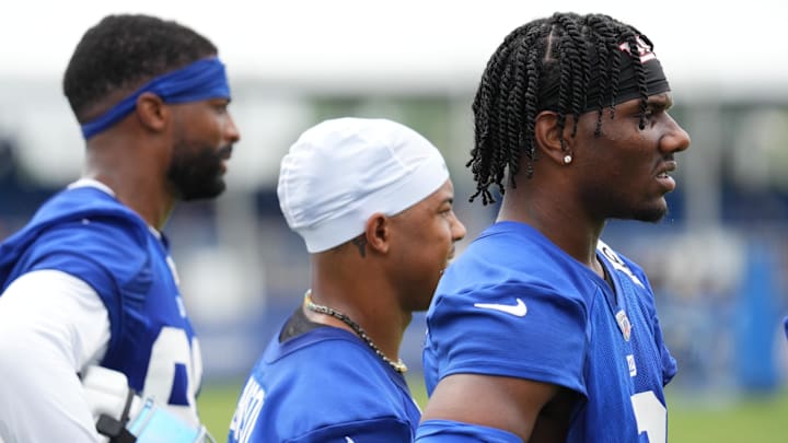 Jul 25, 2024; East Rutherford, NY, USA; New York Giants wide receiver Malik Nabers (right) watches a drill with wide receiver Wan'Dale Robinson (middle) and wide receiver Darius Slayton (left) during training camp at Quest Diagnostics Training Center. Mandatory Credit: Lucas Boland-Imagn Images