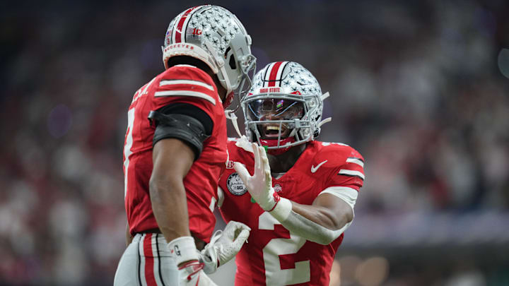 Dec 6, 2025; Indianapolis, IN, USA; Ohio State Buckeyes safety Caleb Downs (2) and cornerback Lorenzo Styles Jr. (3) react in the first half against the Indiana Hoosiers during the 2025 Big Ten championship game at Lucas Oil Stadium. Mandatory Credit: Aaron Doster-Imagn Images Dec 6, 2025; Indianapolis, IN, USA; Ohio State Buckeyes safety Caleb Downs (2) and cornerback Lorenzo Styles Jr. (3) react in the first half against the Indiana Hoosiers during the 2025 Big Ten championship game at Lucas Oil Stadium. Mandatory Credit: Aaron Doster-Imagn Images