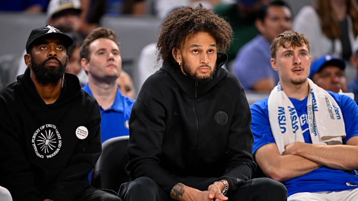 Oct 6, 2025; Fort Worth, Texas, USA; Dallas Mavericks guard Kyrie Irving, center Dereck Lively II, and forward Cooper Flagg look on during the game between the Dallas Mavericks and OKC Thunder.