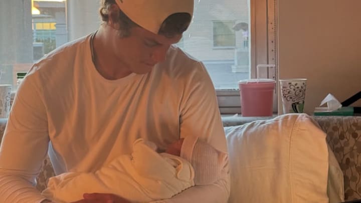 J.J. McCarthy and his newborn son, Rome Micah McCarthy.