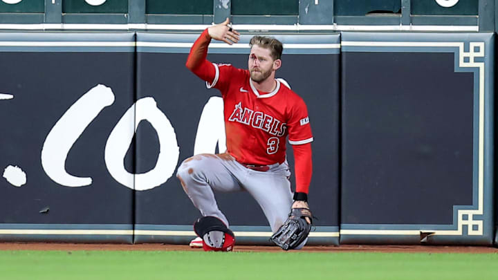 Los Angeles Angels outfield Taylor Ward signals for help after running headfirst into the wall at Daikin Park in Houston.