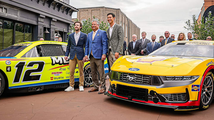 Team Penske drivers Ryan Blaney (left) and Joey Logano (right) pose with the Town of Mooresville Mayor Chris Carney at a proclamation event honoring the team. Team Penske drivers Ryan Blaney (left) and Joey Logano (right) pose with the Town of Mooresville Mayor Chris Carney at a proclamation event honoring the team.