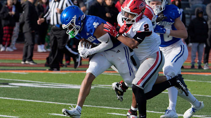 Novi Detroit Catholic Central (5) Samson Gash runs into the end zone for his teams second score of the game as East Kentwood (2) Jaziel Negron defends during the first half of the MHSAA Division 1 football semifinals between Novi Detroit Catholic Central and East Kentwood at Jackson High School in Jackson on Saturday, Nov. 22, 2025. Novi Detroit Catholic Central (5) Samson Gash runs into the end zone for his teams second score of the game as East Kentwood (2) Jaziel Negron defends during the first half of the MHSAA Division 1 football semifinals between Novi Detroit Catholic Central and East Kentwood at Jackson High School in Jackson on Saturday, Nov. 22, 2025.