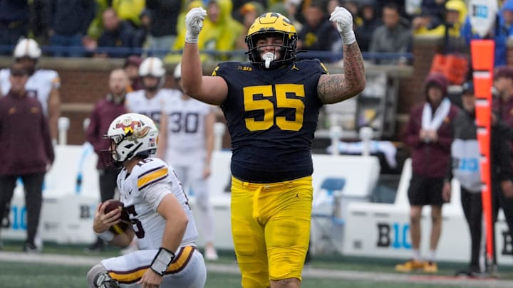 Michigan defensive lineman Mason Graham celebrates after sacking Minnesota quarterback Max Brosmer, in the background, during first-half action between Michigan and Minnesota at Michigan Stadium in Ann Arbor on Saturday, Sept. 28, 2024. Michigan defensive lineman Mason Graham celebrates after sacking Minnesota quarterback Max Brosmer, in the background, during first-half action between Michigan and Minnesota at Michigan Stadium in Ann Arbor on Saturday, Sept. 28, 2024.
