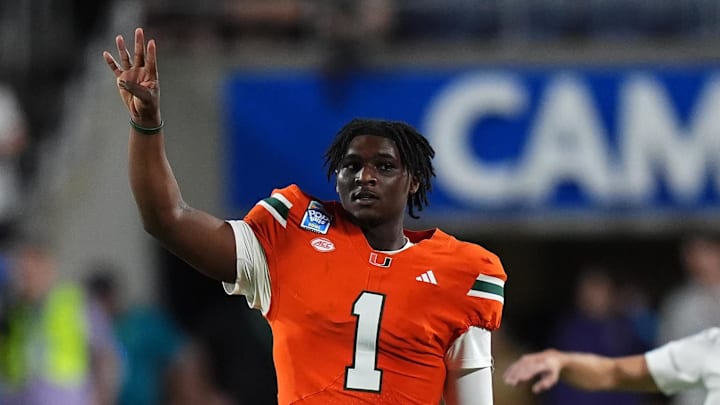 Dec 28, 2024; Orlando, FL, USA; Miami Hurricanes quarterback Cam Ward (1) gestures during the second half against the Iowa State Cyclones  at Camping World Stadium. Mandatory Credit: Jasen Vinlove-Imagn Images