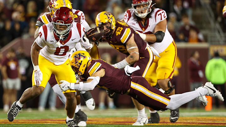 Oct 5, 2024; Minneapolis, Minnesota, USA; USC Trojans running back Quinten Joyner (0) fumbles the ball against the Minnesota Golden Gophers during the first half at Huntington Bank Stadium. 