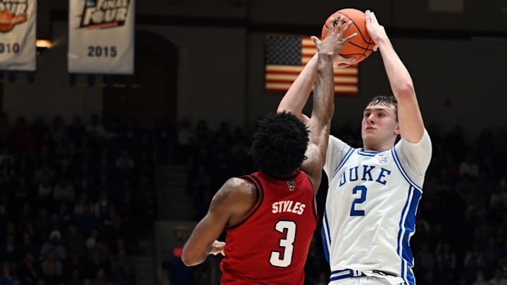 Jan 27, 2025; Durham, North Carolina, USA; Duke basketball forward Cooper Flagg (2) shoots over North Carolina State Wolfpack guard Dontrez Styles (3) during the second half at Cameron Indoor Stadium.  The Blue Devils won 74-64. 