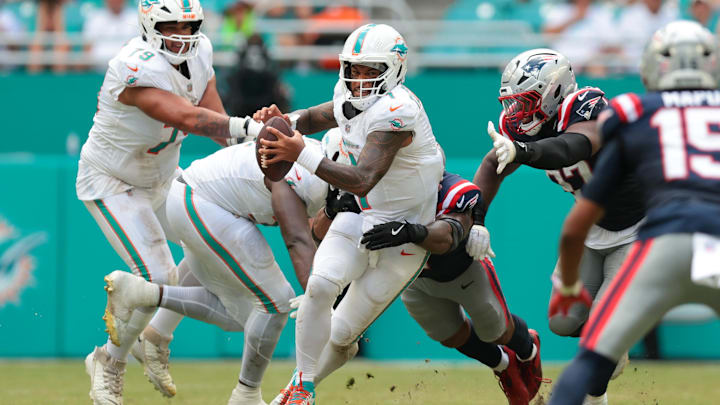 Miami Dolphins quarterback Tua Tagovailoa (1) is sacked by New England Patriots linebacker Harold Landry III (2) during the fourth quarter at Hard Rock Stadium. Miami Dolphins quarterback Tua Tagovailoa (1) is sacked by New England Patriots linebacker Harold Landry III (2) during the fourth quarter at Hard Rock Stadium.