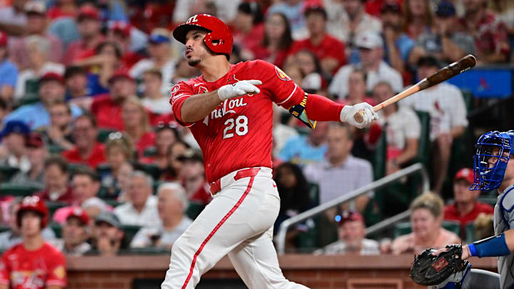 Aug 17, 2024; St. Louis, Missouri, USA;  St. Louis Cardinals third base Nolan Arenado (28) hits a solo home run against the Los Angeles Dodgers in the eighth inning at Busch Stadium.  At right is Los Angeles Dodgers catcher Will Smith. Mandatory Credit: Tim Vizer-Imagn Images