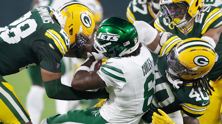 Green Bay Packers linebacker Isaiah Simmons (28) and safety Omar Brown (40) tackle New York Jets wide receiver Malachi Corley.