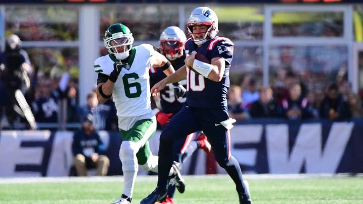 New England Patriots quarterback Drake Maye (10) runs with the ball while New York Jets safety Dane Belton (6) gives chase during the second half at Gillette Stadium. New England Patriots quarterback Drake Maye (10) runs with the ball while New York Jets safety Dane Belton (6) gives chase during the second half at Gillette Stadium.