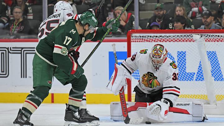 Sep 28, 2025; Saint Paul, Minnesota, USA; Chicago Blackhawks goalie Drew Commesso (33 freezes the puck as defensemen Artyom Levshunov (55) ties up Minnesota Wild forward Marcus Foligno (17) during the third period at Xcel Energy Center. Mandatory Credit: Nick Wosika-Imagn Images
Sep 28, 2025; Saint Paul, Minnesota, USA; Chicago Blackhawks goalie Drew Commesso (33 freezes the puck as defensemen Artyom Levshunov (55) ties up Minnesota Wild forward Marcus Foligno (17) during the third period at Xcel Energy Center. Mandatory Credit: Nick Wosika-Imagn Images