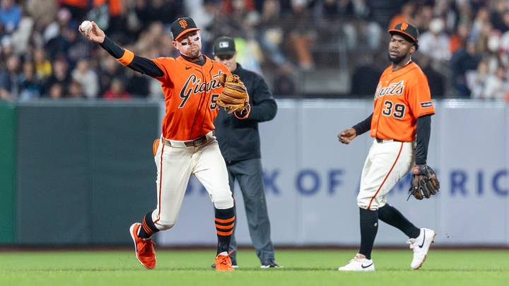 Sep 11, 2026; San Francisco, California, USA;  San Francisco Giants third baseman Christian Koss (50) makes a play at first during the sixth inning against the San Diego Padres at Oracle Park.  Mandatory Credit: Bob Kupbens-Imagn Images