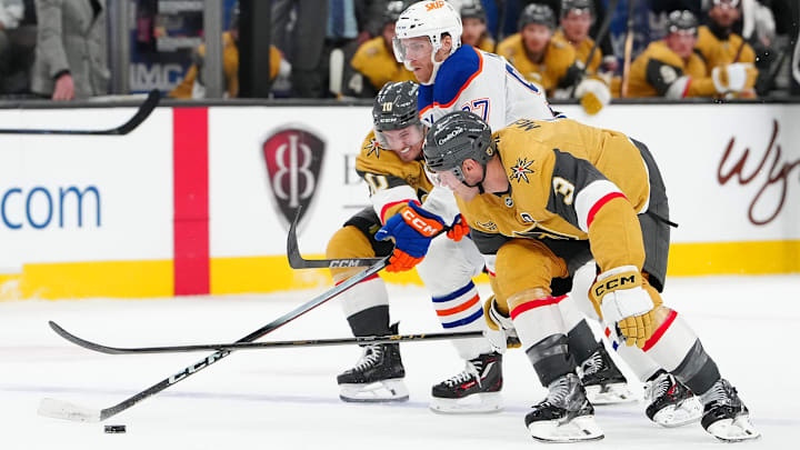 Mar 8, 2026; Las Vegas, Nevada, USA;Edmonton Oilers center Connor McDavid (97) skates between Vegas Golden Knights center Colton Sissons (10) and Vegas Golden Knights defenseman Brayden McNabb (3) during the second period  at T-Mobile Arena. Mandatory Credit: Stephen R. Sylvanie-Imagn Images