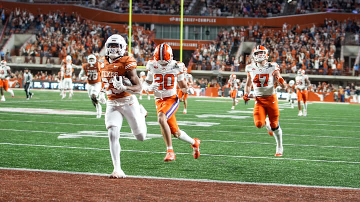 Texas Longhorns running back Jaydon Blue (23) runs into the endzone for a touchdown against Clemson Tigers cornerback Avieon Terrell (20) and Clemson Tigers linebacker Sammy Brown (47) in the second half of an NCAA College Football Playoffs first round game at Darrell K Royal Texas Memorial Stadium, Austin, Texas, Saturday, Dec. 21, 2024. Texas Longhorns running back Jaydon Blue (23) runs into the endzone for a touchdown against Clemson Tigers cornerback Avieon Terrell (20) and Clemson Tigers linebacker Sammy Brown (47) in the second half of an NCAA College Football Playoffs first round game at Darrell K Royal Texas Memorial Stadium, Austin, Texas, Saturday, Dec. 21, 2024.