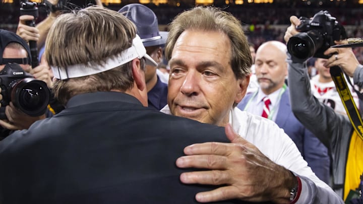 Jan 10, 2022; Indianapolis, IN, USA; Alabama Crimson Tide head coach Nick Saban and Georgia Bulldogs head coach Kirby Smart embrace and talk after the 2022 CFP college football national championship game at Lucas Oil Stadium. Mandatory Credit: Mark J. Rebilas-Imagn Images