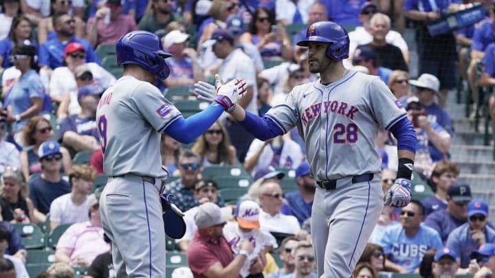 Jun 21, 2024; Chicago, Illinois, USA; New York Mets designated hitter J.D. Martinez (28) is greeted by  outfielder Brandon Nimmo (9) after hitting a three-run home run against the Chicago Cubs during the first inning at Wrigley Field. Mandatory Credit: David Banks-USA TODAY Sports