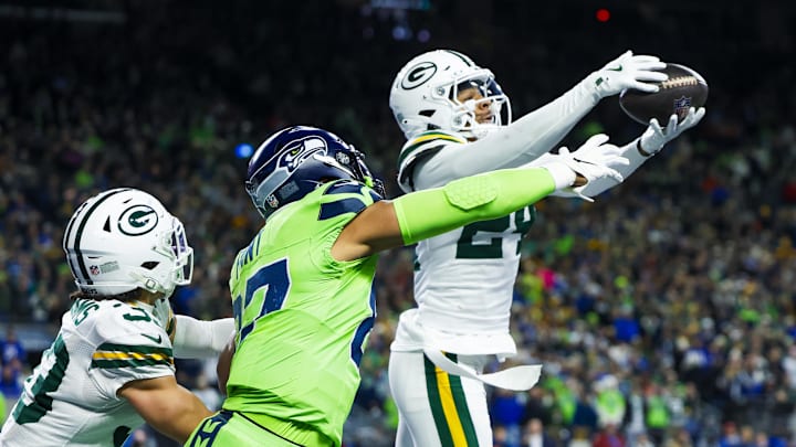 Green Bay Packers cornerback Carrington Valentine (24) intercepts a pass against Seattle Seahawks tight end Noah Fant. Green Bay Packers cornerback Carrington Valentine (24) intercepts a pass against Seattle Seahawks tight end Noah Fant.