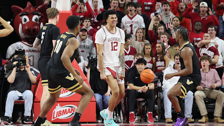Jan 20, 2026; Fayetteville, Arkansas, USA; Arkansas Razorbacks forward Malique Ewin (12) reacts after dunking the ball during the second half against the Vanderbilt Commodores at Bud Walton Arena. Arkansas won 93-68. Mandatory Credit: Nelson Chenault-Imagn Images