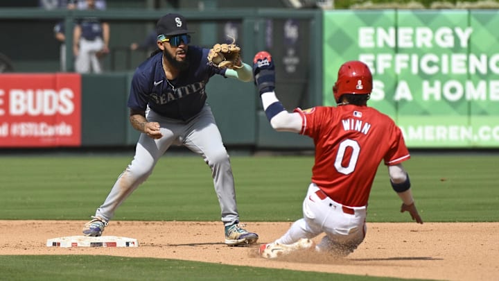Seattle Mariners shortstop JP Crawford (left) helps turn a double play during a game against the St. Louis Cardinals on Sept. 8 at Busch Stadium.