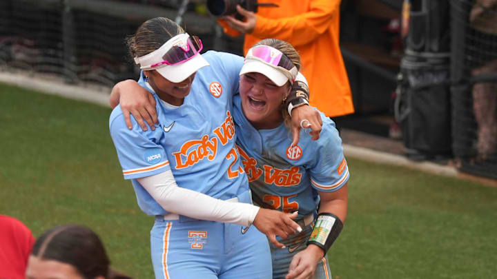 Tennessee utility Ella Dodge and Tennessee outfielder Kinsey Fiedler smile after winning a NCAA super regionals softball game against the Nebraska Cornhuskers and advancing to the Women's College World Series.