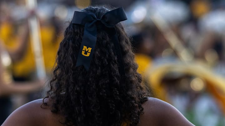 Sept 27, 2025; Columbia, Missouri, USA; A Missouri Tigers cheerleader watches the Marching Mizzou band ahead of a game UMass at Faurot Field at Memorial Stadium. 