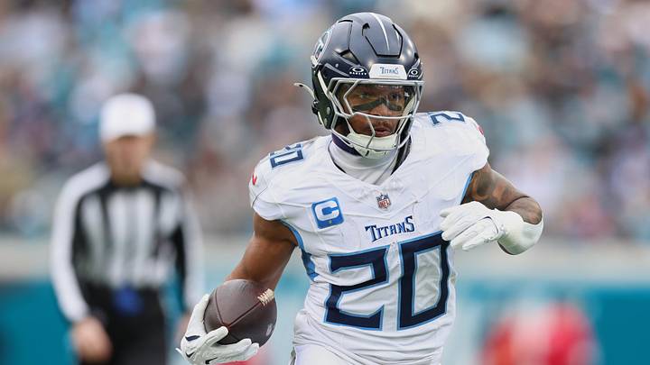 Jan 4, 2026; Jacksonville, Florida, USA; Tennessee Titans running back Tony Pollard (20) runs the ball against the Jacksonville Jaguars during the first quarter at EverBank Stadium. Mandatory Credit: Morgan Tencza-Imagn Images