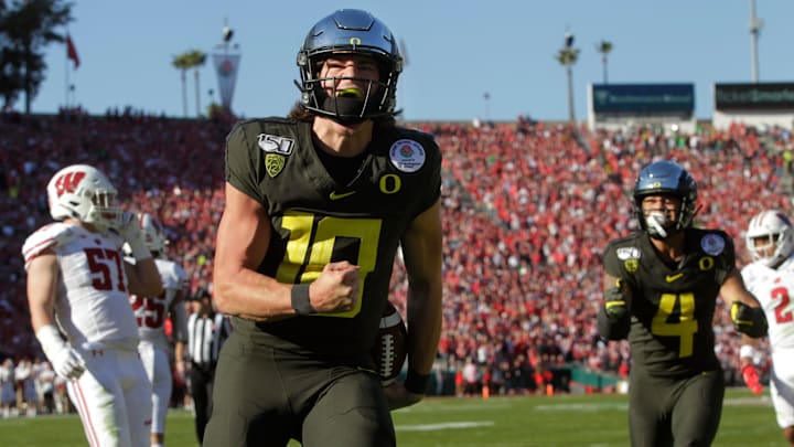 Oregon's Justin Herbert celebrates a first quarter touchdown against Wisconsin in the Rose Bowl in Pasadena on New Years Day 2020.