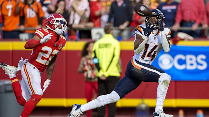 Nov 10, 2024; Kansas City, Missouri, USA; Denver Broncos wide receiver Courtland Sutton (14) catches a touchdown pass against Kansas City Chiefs cornerback Trent McDuffie (22) during the first half at GEHA Field at Arrowhead Stadium. Mandatory Credit: Jay Biggerstaff-Imagn Images