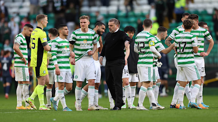 Ange Postecoglou (centre) is leading Celtic's bid to retain the Scottish top flight title