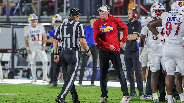 Oct 4, 2025; Orlando, Florida, USA; Kansas Jayhawks head coach Lance Leipold talks with an official during the second quarter against the UCF Knights at FBC Mortgage Stadium. Mandatory Credit: Mike Watters-Imagn Images Oct 4, 2025; Orlando, Florida, USA; Kansas Jayhawks head coach Lance Leipold talks with an official during the second quarter against the UCF Knights at FBC Mortgage Stadium. Mandatory Credit: Mike Watters-Imagn Images