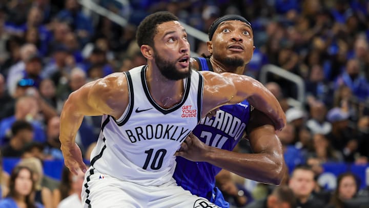 Brooklyn Nets guard Ben Simmons (10) and Orlando Magic center Wendell Carter Jr. (34) look for the rebound during the second half at Kia Center.