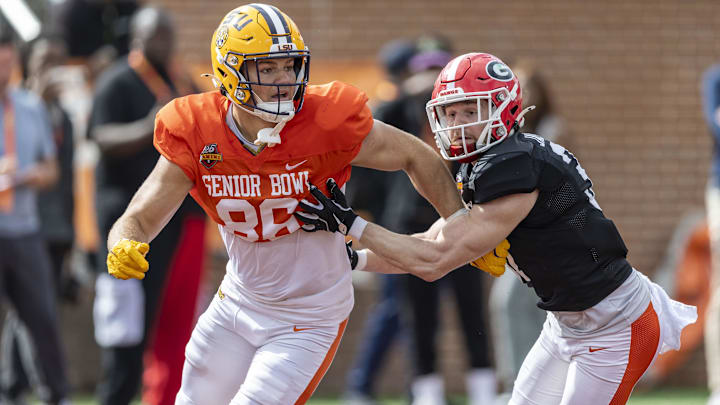 Jan 30, 2025; Mobile, AL, USA; American team tight end Mason Taylor of LSU (86) and American team defensive back Dan Jackson of Georgia (37) spar during Senior Bowl practice for the American team at Hancock Whitney Stadium. Mandatory Credit: Vasha Hunt-Imagn Images