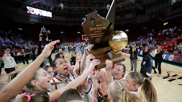 Oostburg High School's basketball players celebrate their victory against Wisconsin Dells High School during their WIAA Division 3 championship girls basketball game on March 14, 2026.
