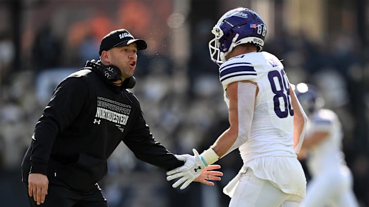 Nov 2, 2024; West Lafayette, Indiana, USA; Northwestern Wildcats head coach David Braun high fives Northwestern Wildcats tight end Marshall Lang (88) during the second quarter at Ross-Ade Stadium. Mandatory Credit: Marc Lebryk-Imagn Images
