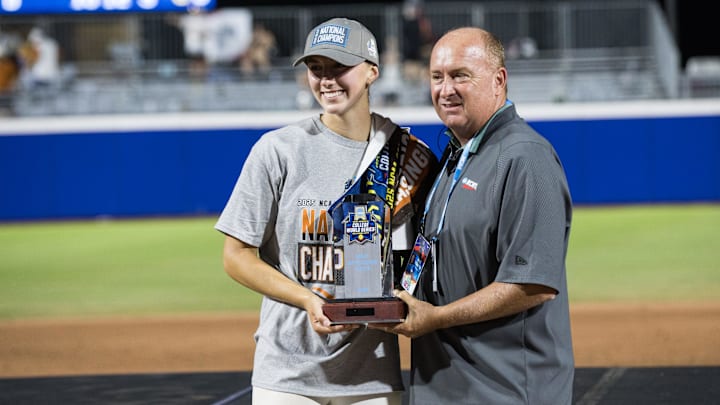 Jun 6, 2025; Oklahoma City, OK, USA;  Kurt McGuffin presents Texas Longhorns pitcher Teagan Kavan (17) thee Most Valuable Player trophy after the Longhorns beat the Texas Tech Red Raiders 10-4 to win the National Champion in game three of the NCAA Softball Women's College World Series finals at Devon Park. Mandatory Credit: Brett Rojo-Imagn Images